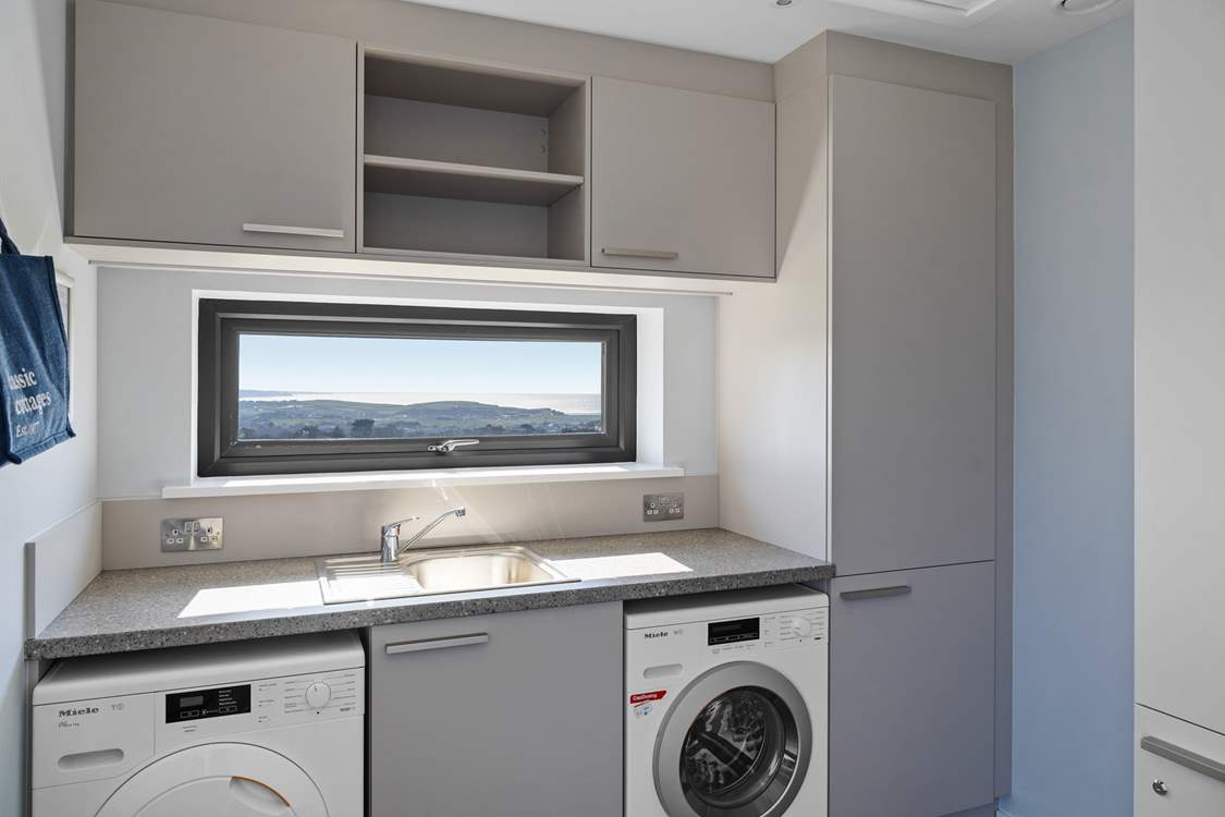 The utility-area sits off of the kitchen next to the front door.