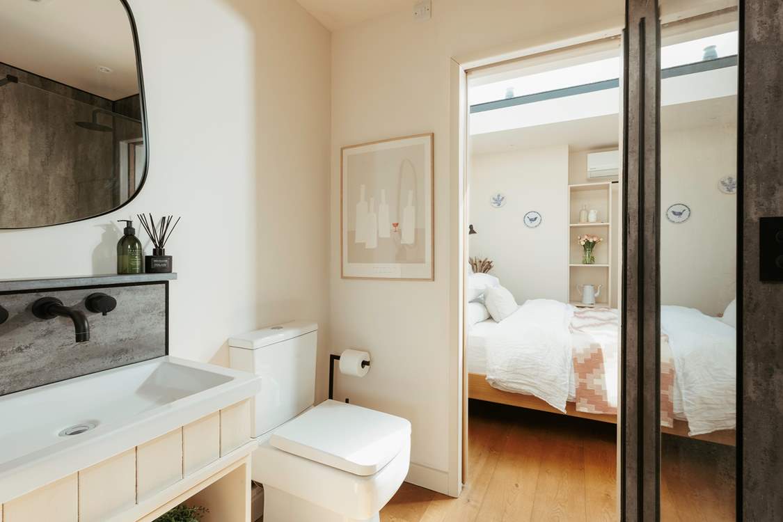 The bathroom resides between the main living space and the bedroom.