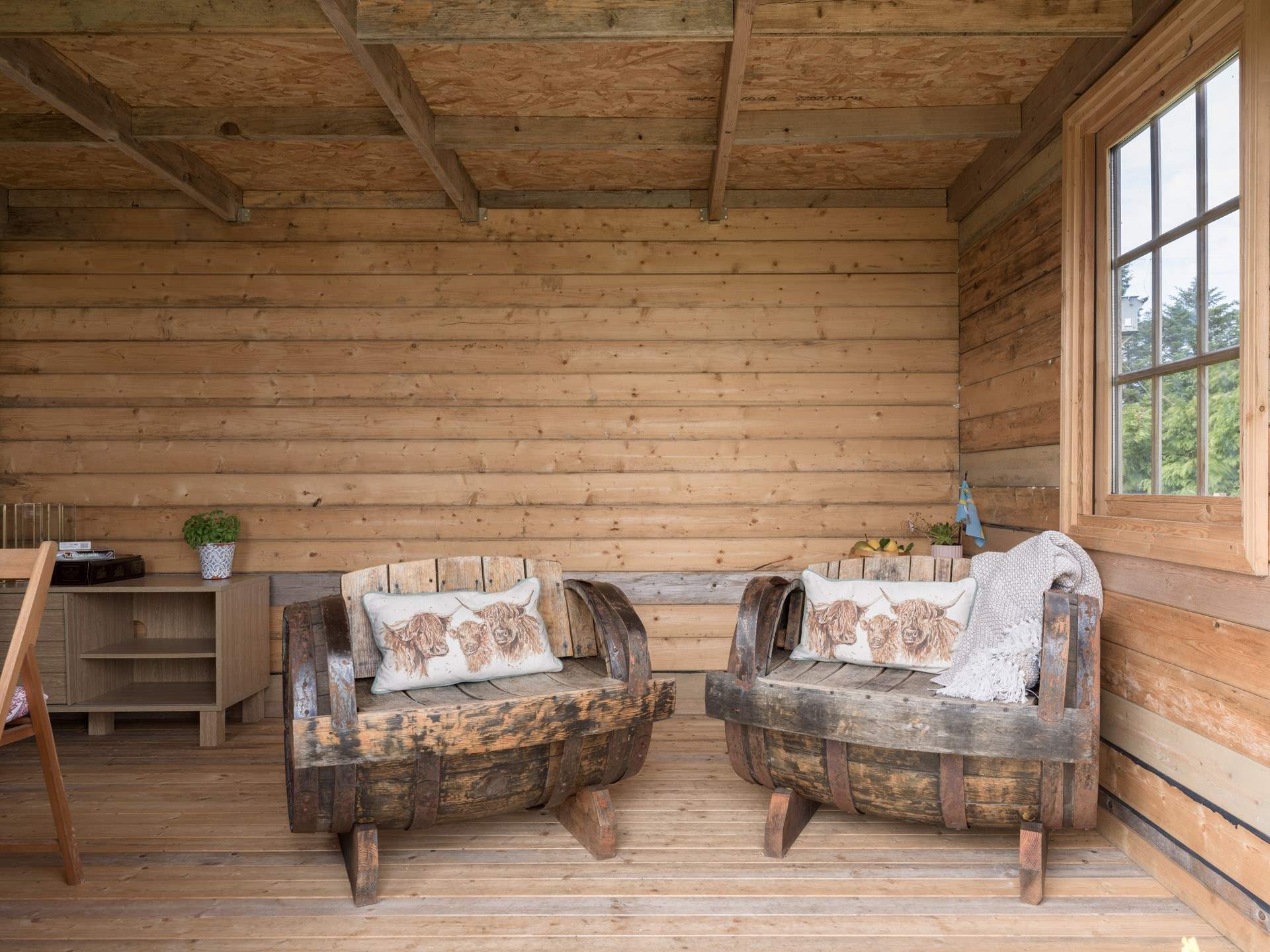 Relax in the summer-house, a lovely place to sit in rain or shine. 