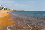 A picturesque walk down the hill leads to the golden beach. 