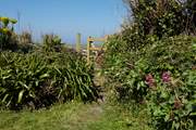 A gateway leads though to a further garden-area.