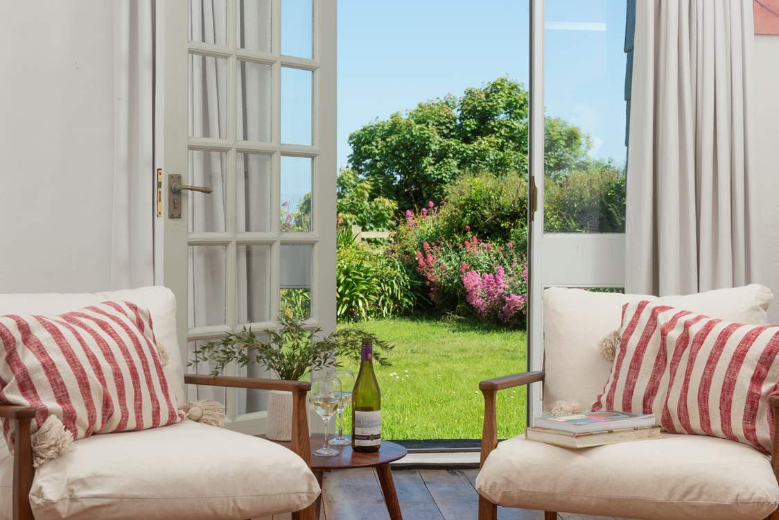 French windows lead from the sitting-room out to the garden.