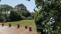 Mature gardens at the rear.