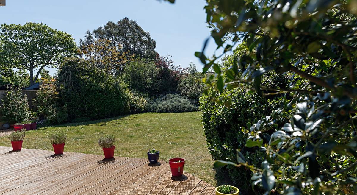 Mature gardens at the rear.
