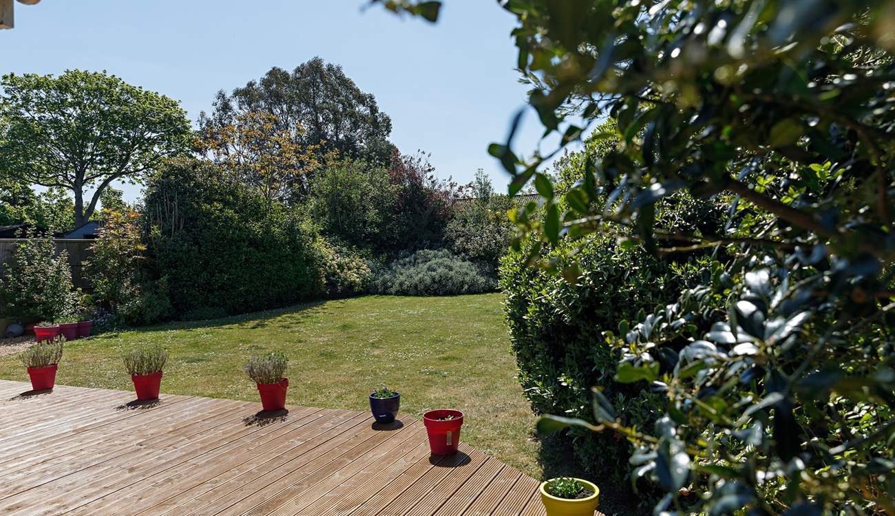 Mature gardens at the rear.