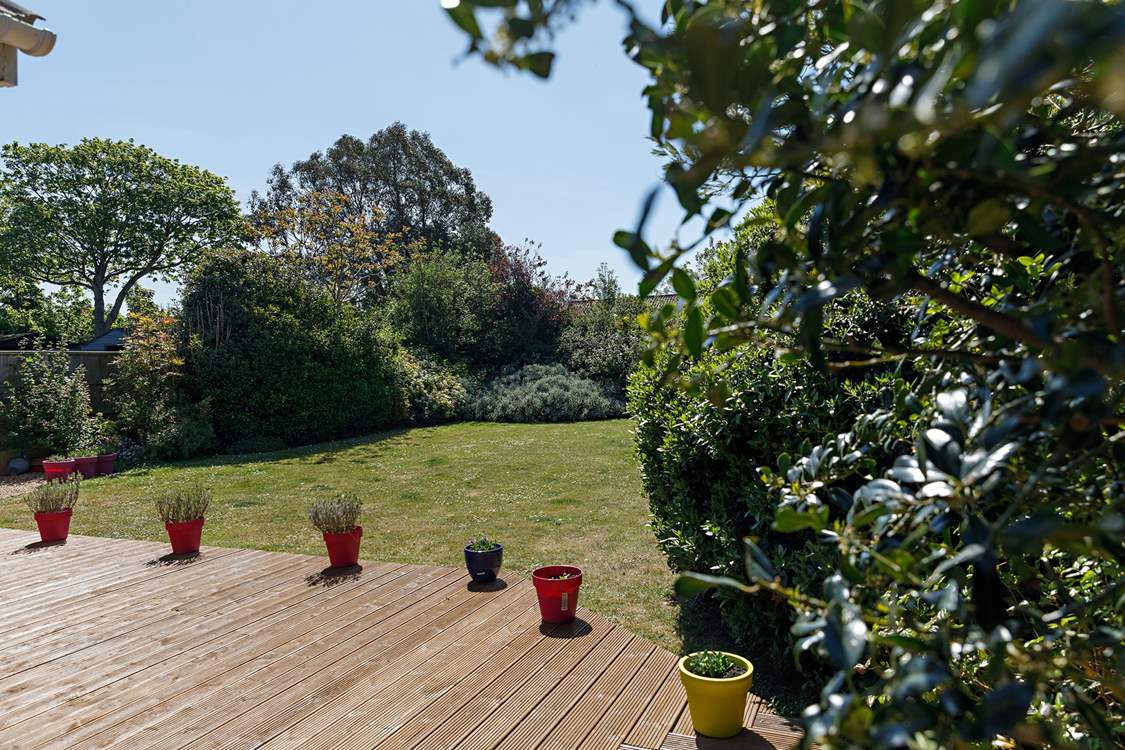 Mature gardens at the rear.