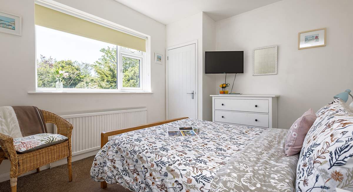 The main bedroom has lovely views of the private garden.
