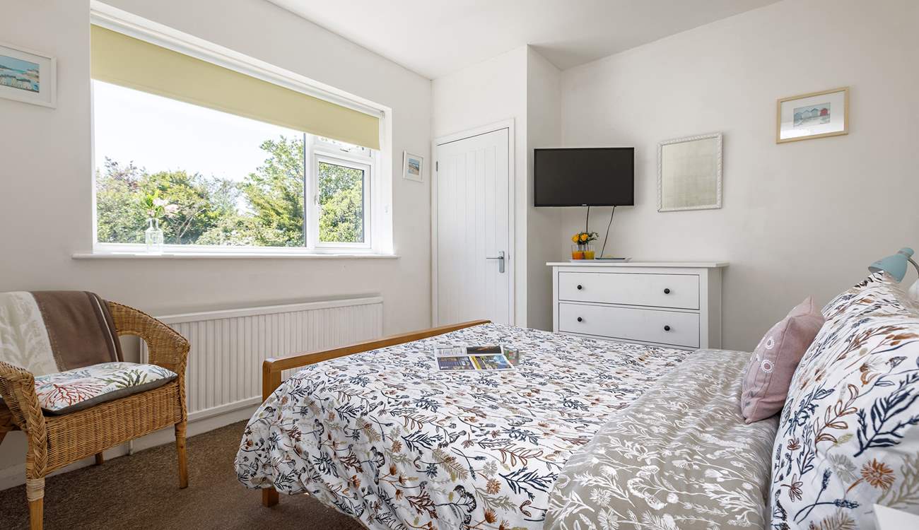 The main bedroom has lovely views of the private garden.