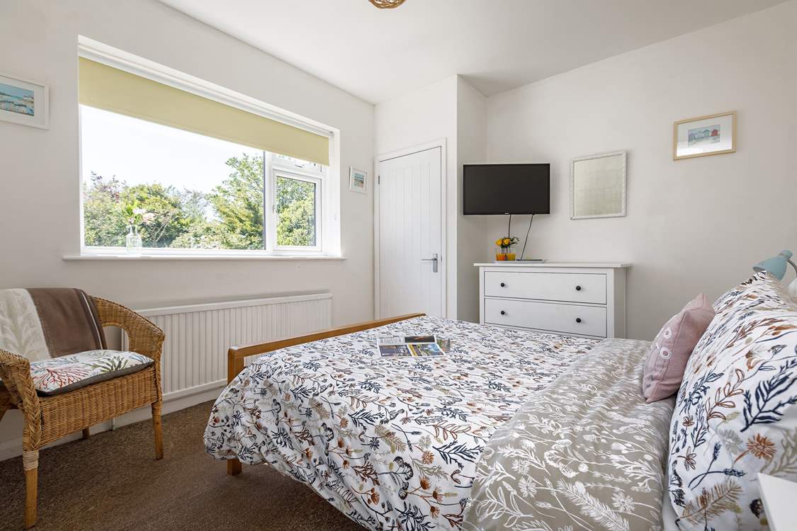 The main bedroom has lovely views of the private garden.