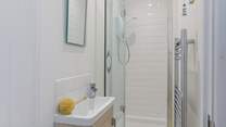 The en suite has a small shower cubicle and wash-basin - please note, there is a no WC however there is a separate WC next door as well as in the main bathroom.