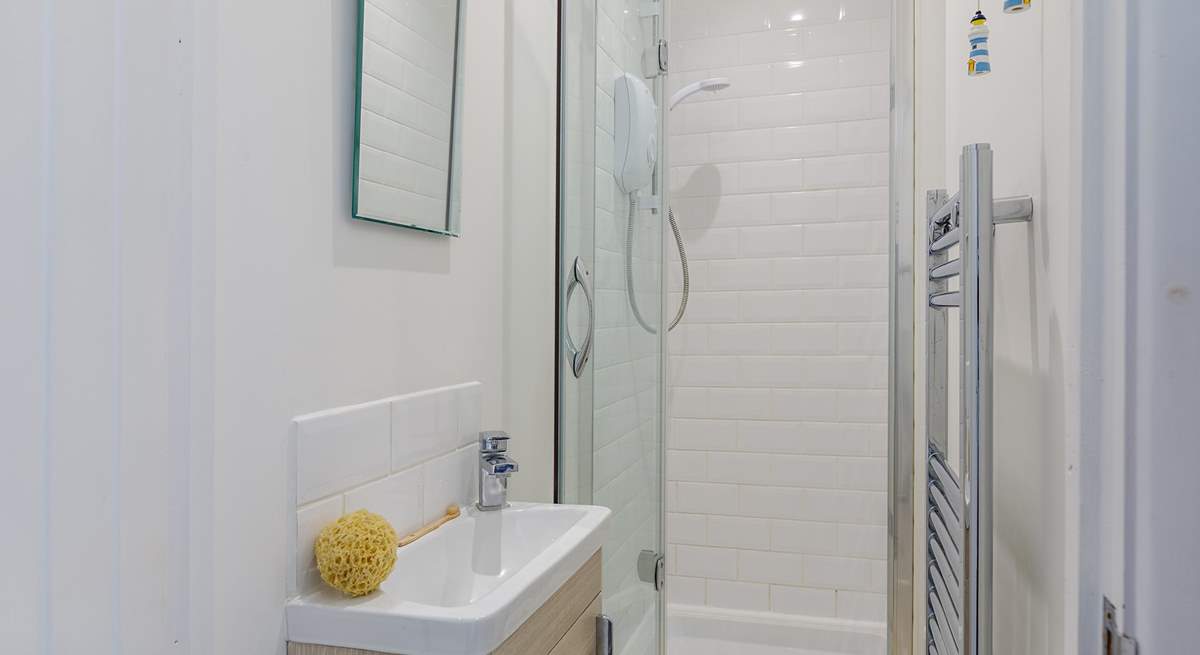 The en suite has a small shower cubicle and wash-basin - please note, there is a no WC however there is a separate WC next door as well as in the main bathroom.