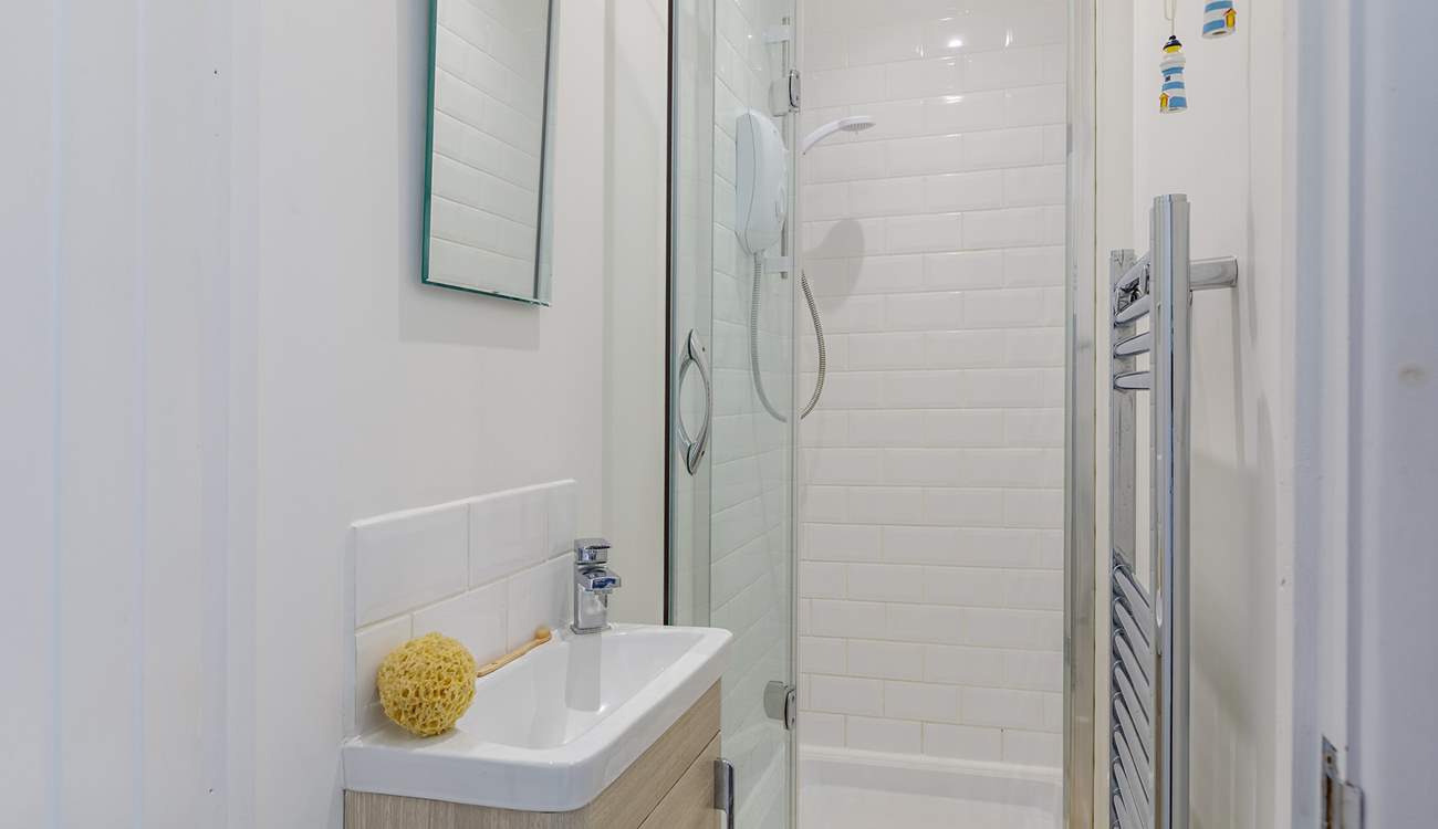 The en suite has a small shower cubicle and wash-basin - please note, there is a no WC however there is a separate WC next door as well as in the main bathroom.