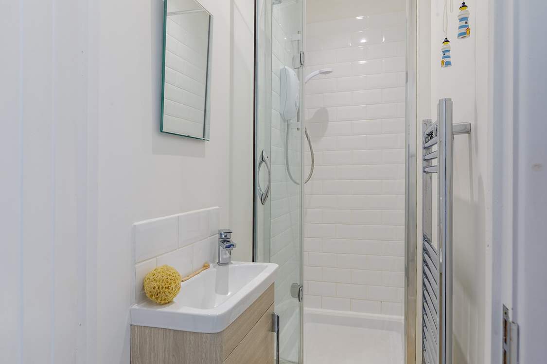 The en suite has a small shower cubicle and wash-basin - please note, there is a no WC however there is a separate WC next door as well as in the main bathroom.