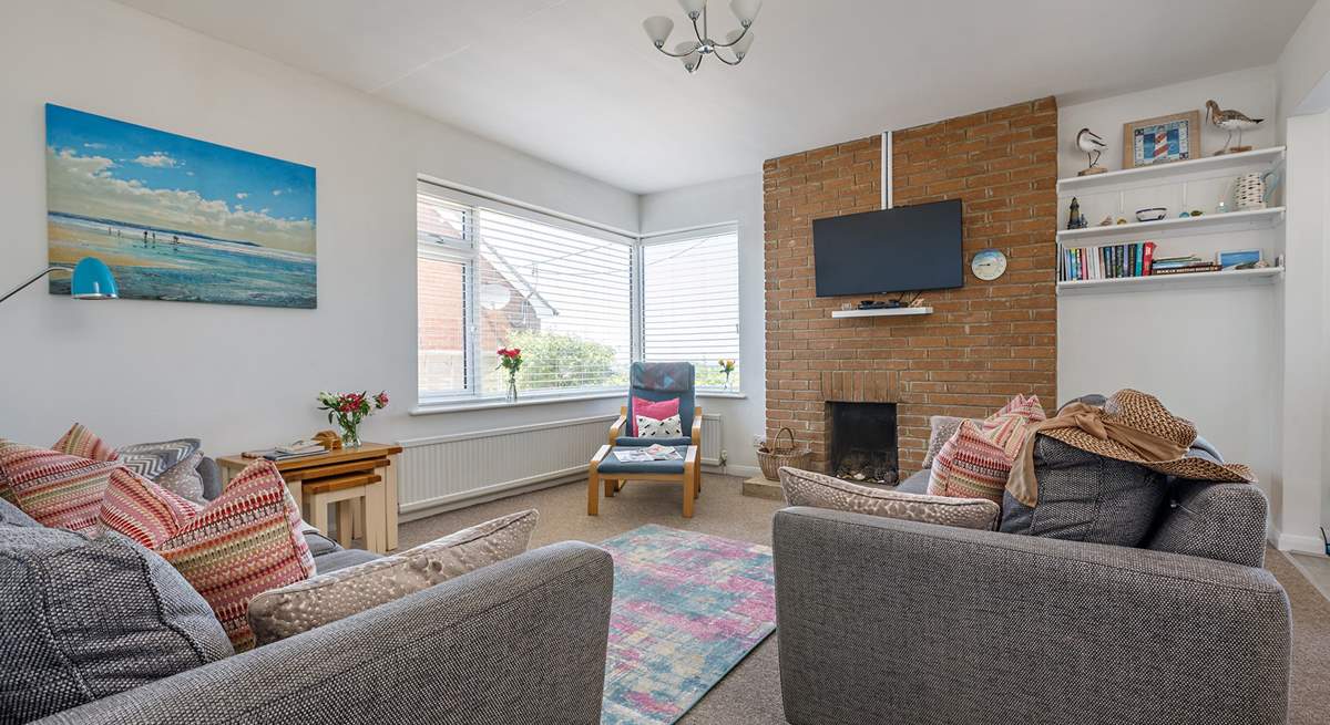 Relax on the comfy sofas in the light-filled sitting-room.