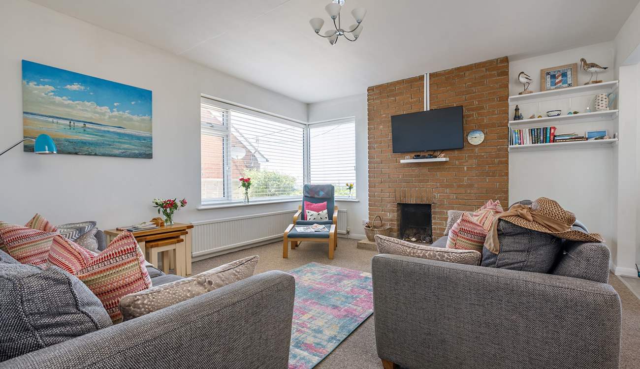 Relax on the comfy sofas in the light-filled sitting-room.