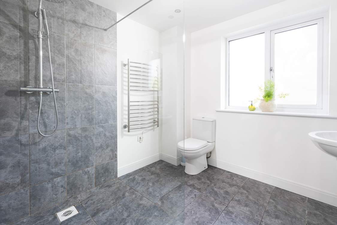 The huge wet-room with power shower is on the ground floor next to the bedroom.