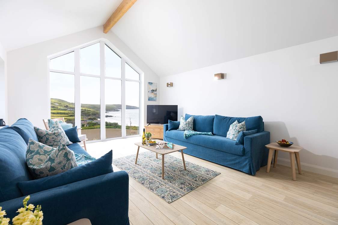 Floor to ceiling windows reflect the exceptional view of the coastline below.