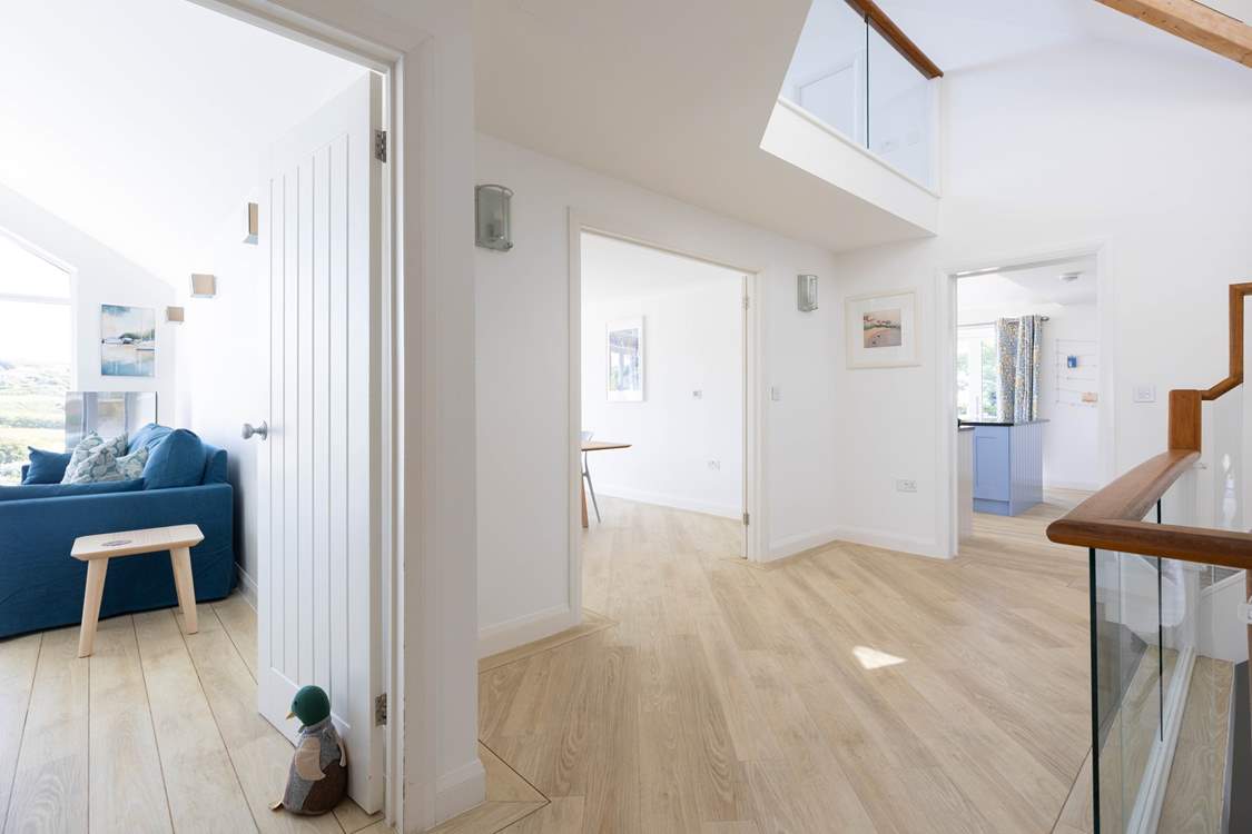 The entrance hall, one bedroom sits on the ground floor, one upstairs and for the other four, head down the stairs.