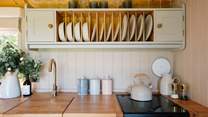 The cute kitchen is well-equipped for your getaway. 