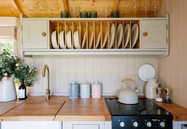 The cute kitchen is well-equipped for your getaway. 