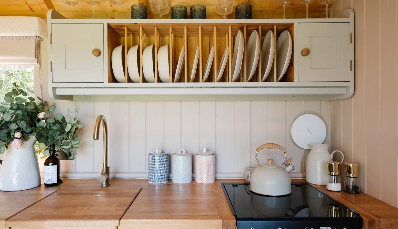 The cute kitchen is well-equipped for your getaway. 