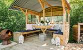 Light the fire-pit, sit back, and relax in the gorgeous outdoor seating area.  - Thumbnail Image