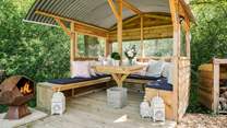 Light the fire-pit, sit back, and relax in the gorgeous outdoor seating area. 