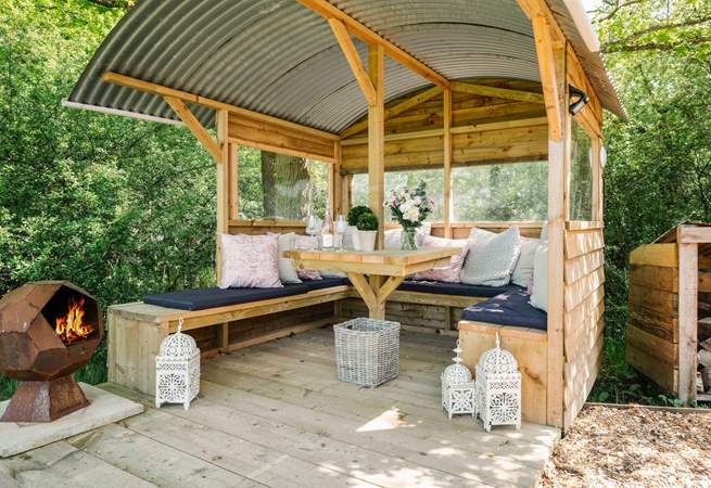 Light the fire-pit, sit back, and relax in the gorgeous outdoor seating area. 