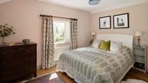 A calming bedroom with beautiful views. 