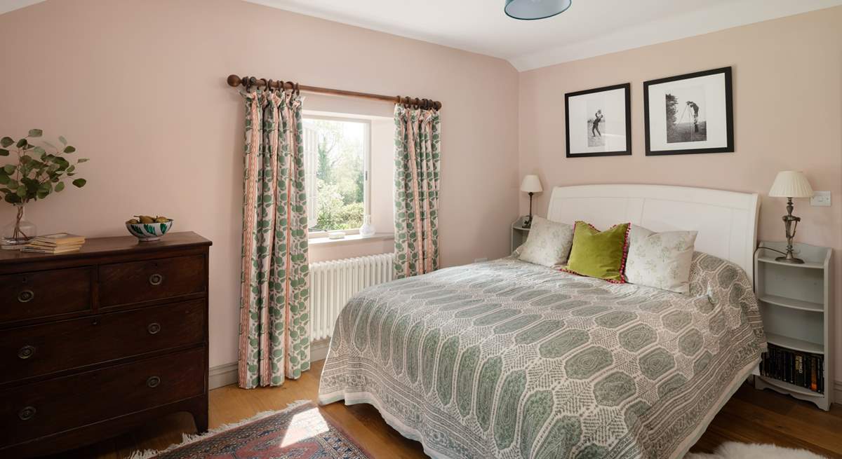 A calming bedroom with beautiful views. 