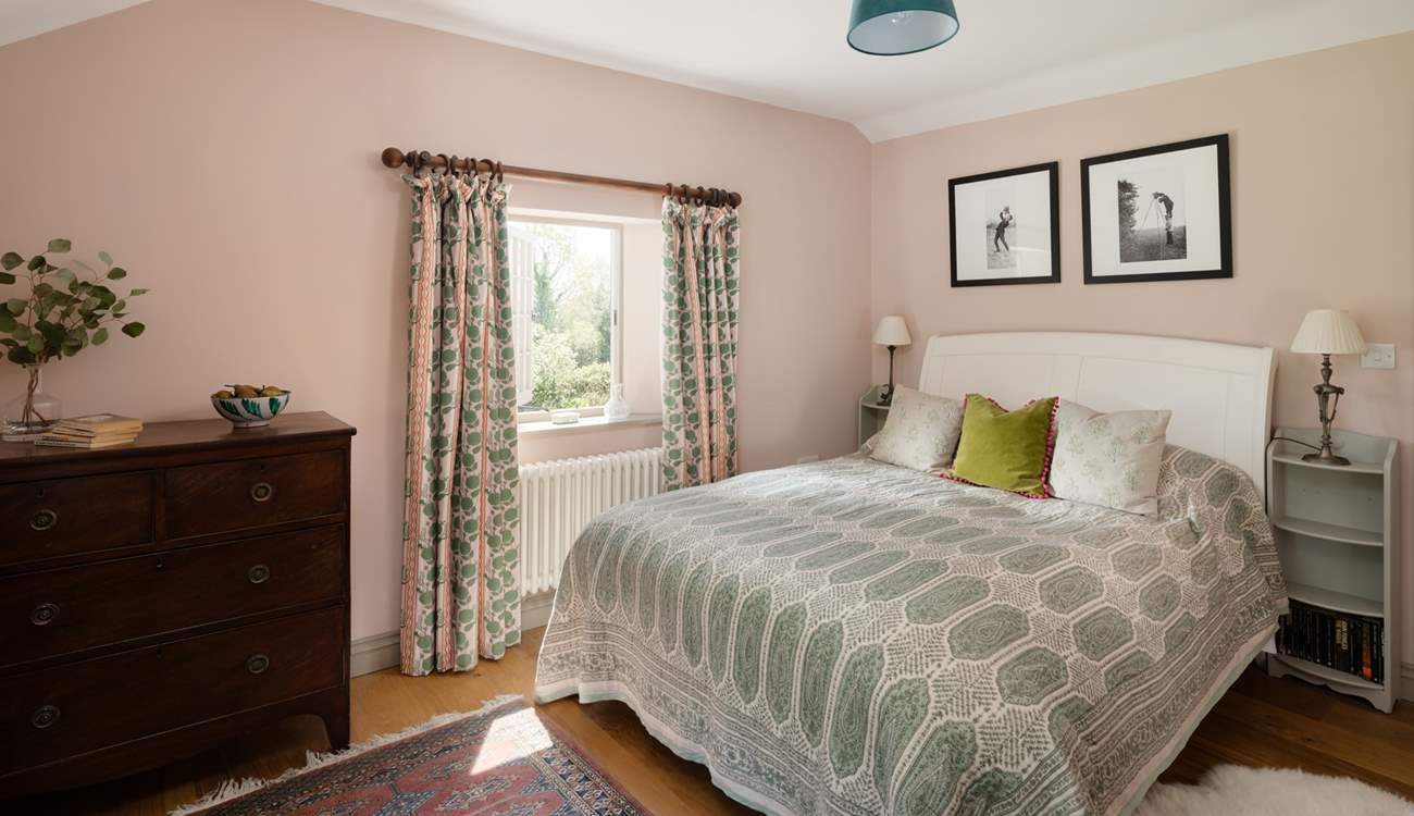 A calming bedroom with beautiful views. 