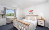 A huge king-size bedroom upstairs has outstanding views. - Thumbnail Image