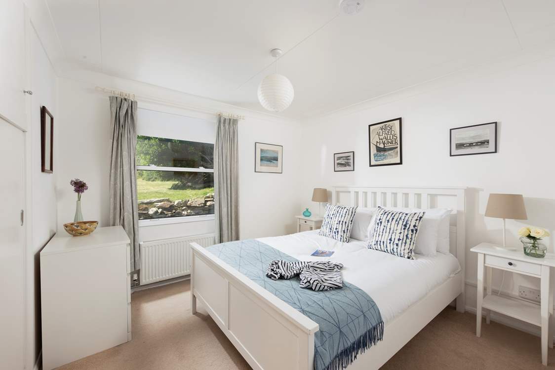 A king-size bedroom on the ground floor overlooking the gorgeous garden.