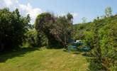A charming back garden with plenty of places to sit back and relax. - Thumbnail Image