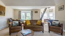 The spacious sitting-room where the sunshine floods in from the triple-aspect windows.
