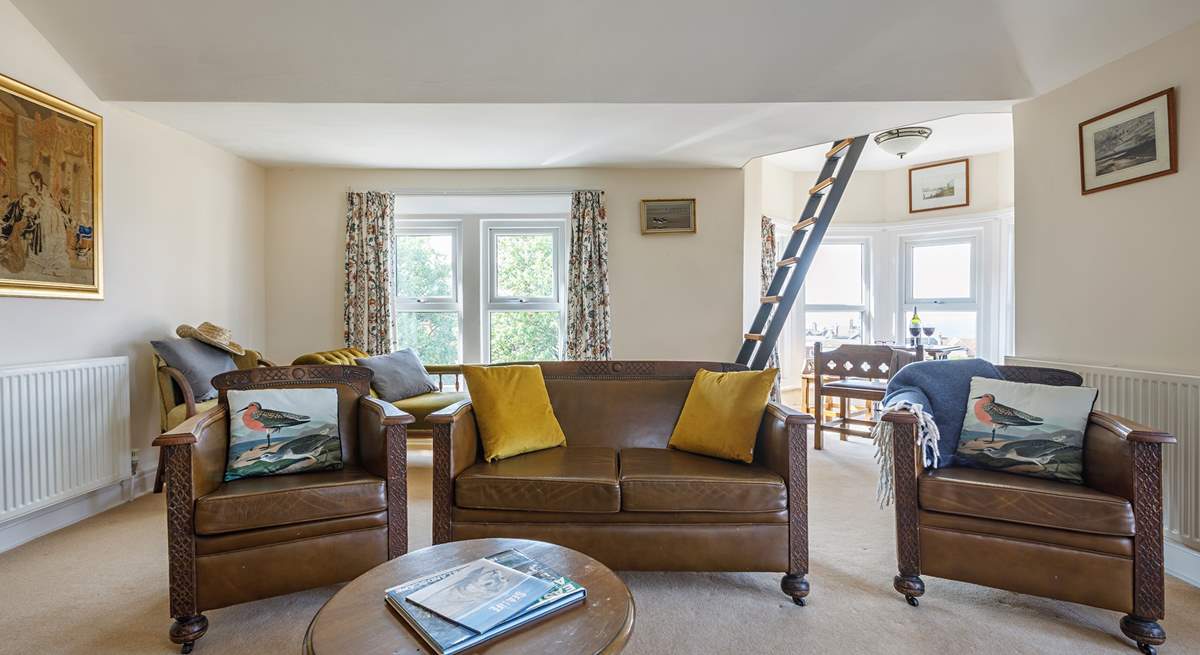 The spacious sitting-room where the sunshine floods in from the triple-aspect windows.