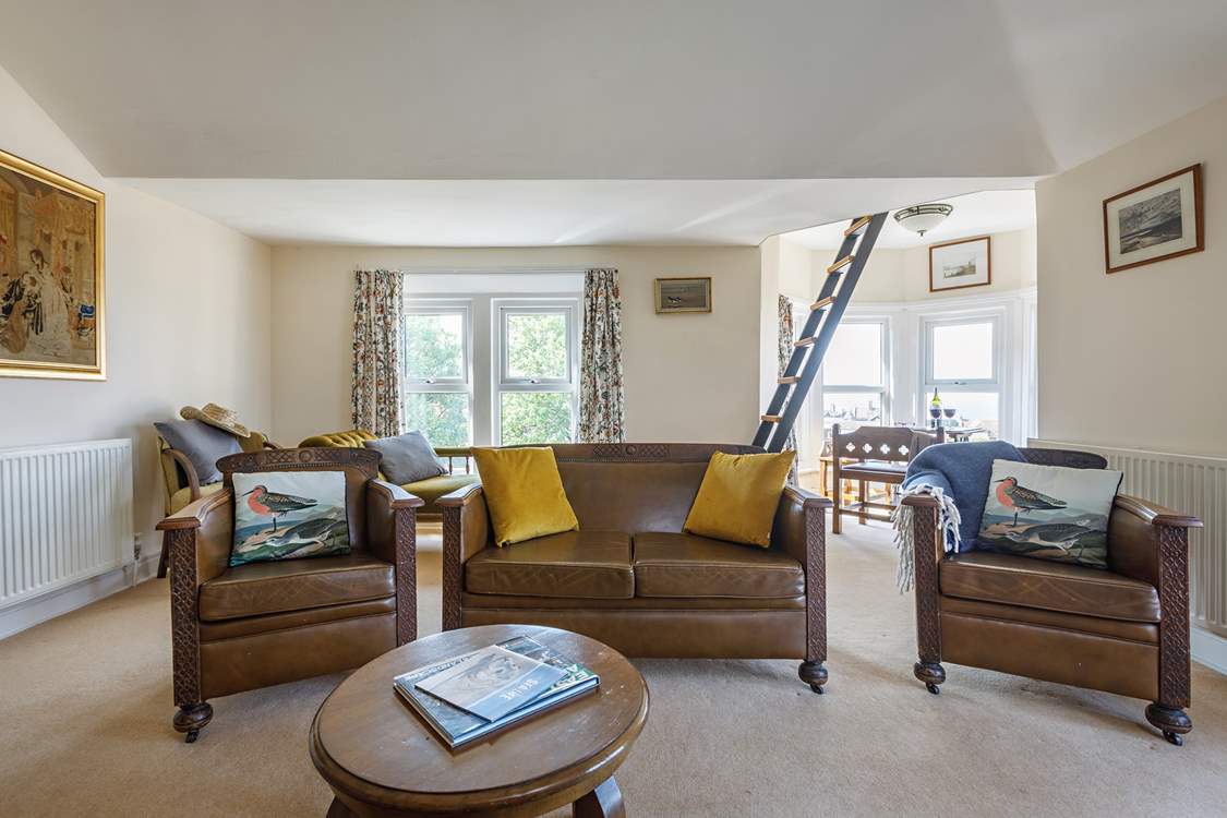 The spacious sitting-room where the sunshine floods in from the triple-aspect windows.