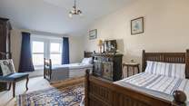Full-size twin beds in the spacious second bedroom.