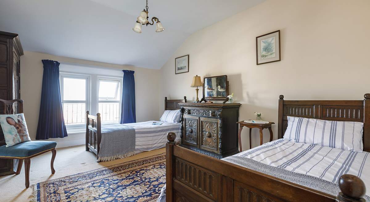 Full-size twin beds in the spacious second bedroom.