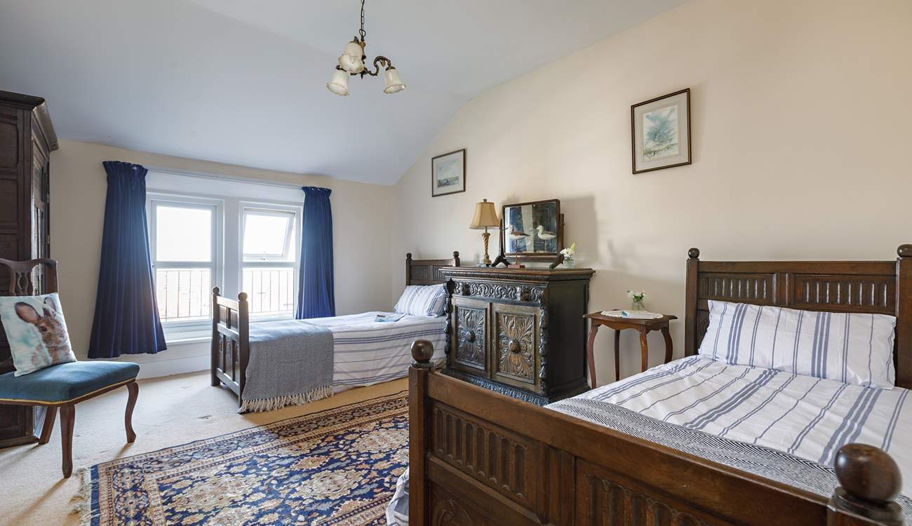 Full-size twin beds in the spacious second bedroom.