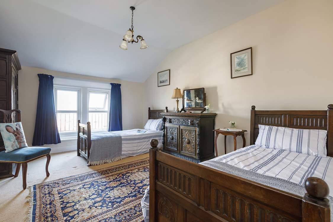 Full-size twin beds in the spacious second bedroom.