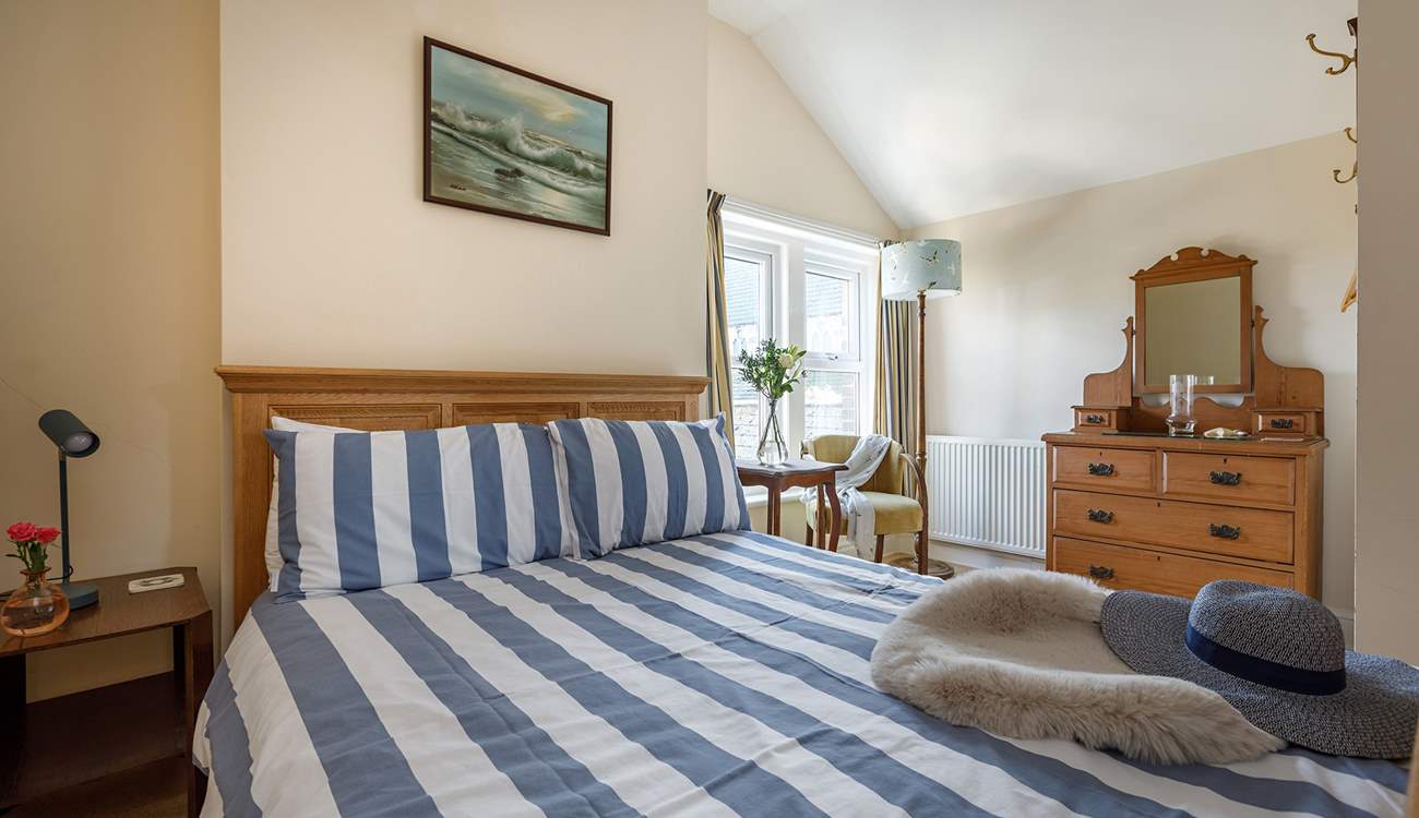 A comfy double bed awaits in this relaxing space.