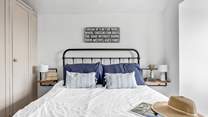 A restful sleep awaits in this king-size bed.