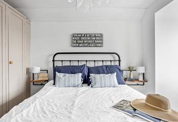 A restful sleep awaits in this king-size bed.