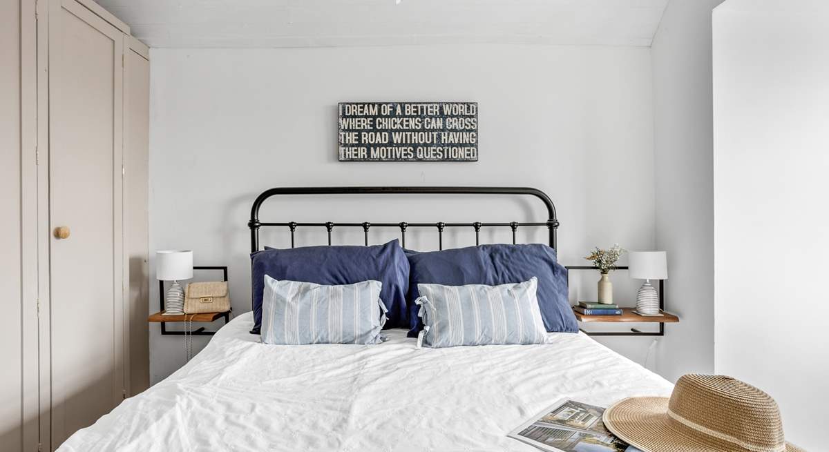 A restful sleep awaits in this king-size bed.