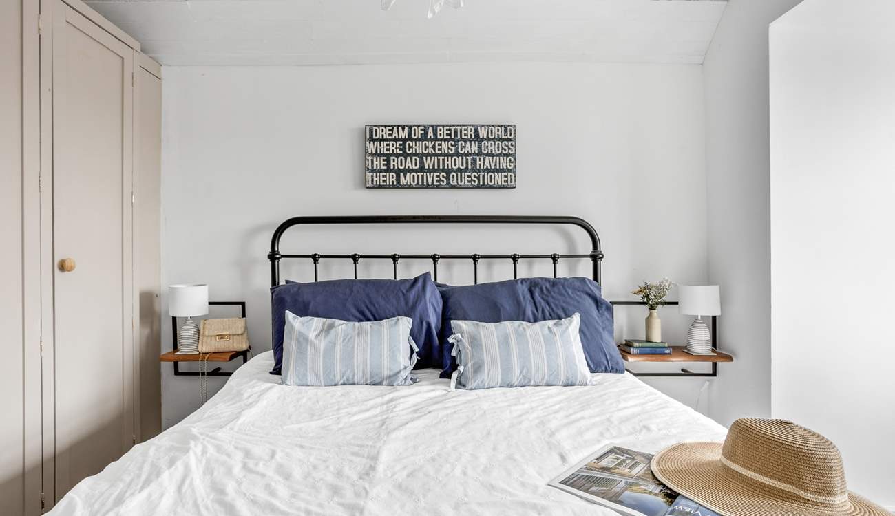 A restful sleep awaits in this king-size bed.