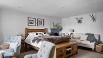 A bedroom of dreams with lots of seating options.