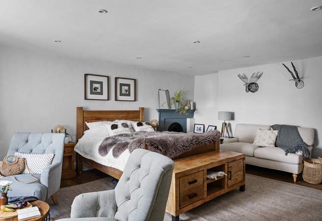 A bedroom of dreams with lots of seating options.