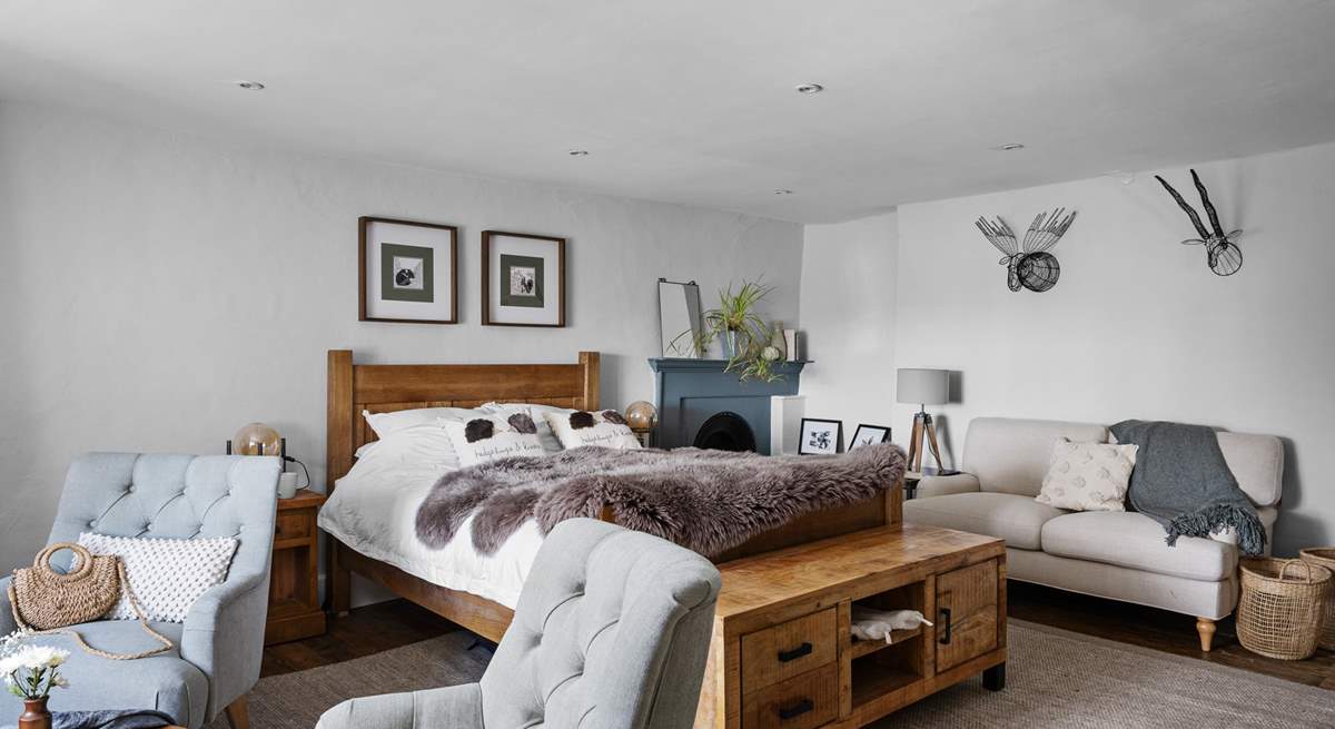 A bedroom of dreams with lots of seating options.