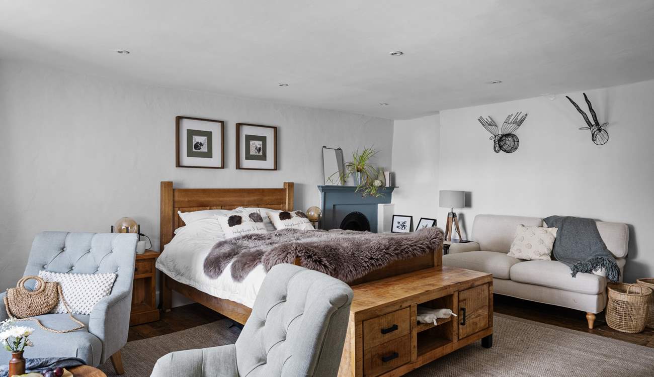 A bedroom of dreams with lots of seating options.